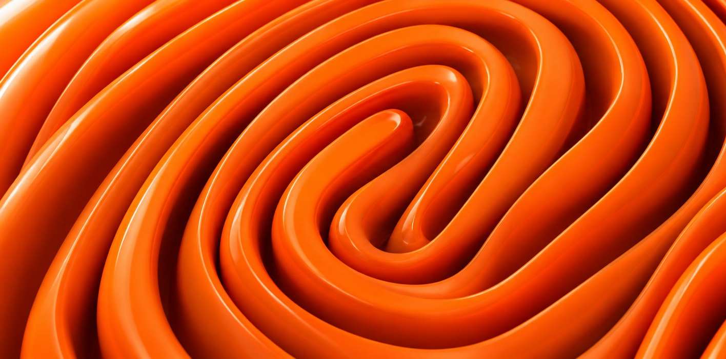 Glossy orange tubes coiled into a fingerprint pattern