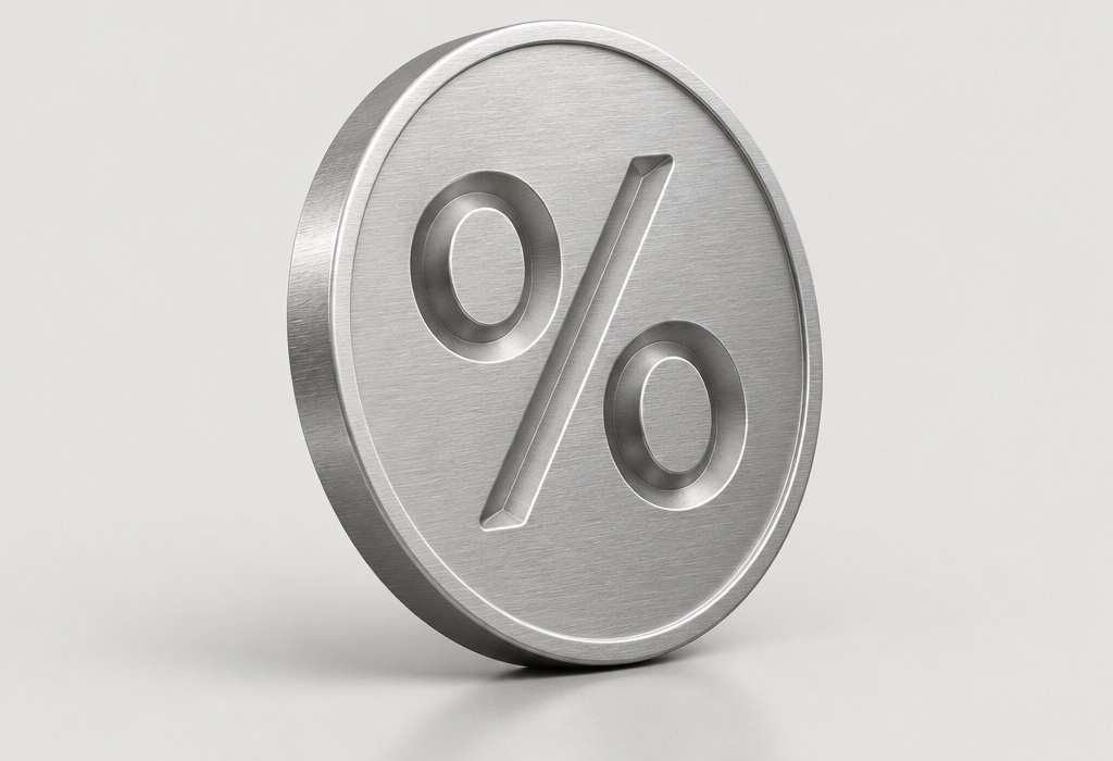 A brushed steel coin with a percent sign on a light grey background